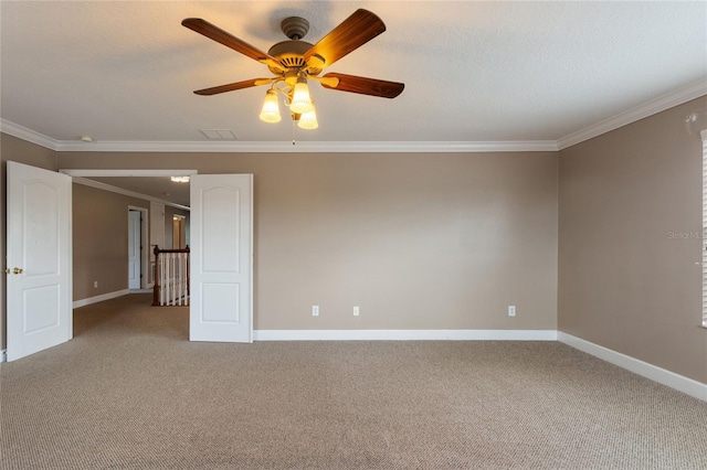 carpeted empty room with ornamental molding, ceiling fan, and a textured ceiling