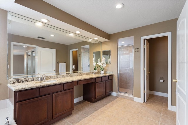 bathroom with vanity, an enclosed shower, tile patterned flooring, and a textured ceiling