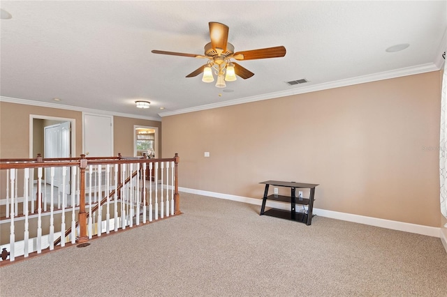 empty room with crown molding and carpet flooring