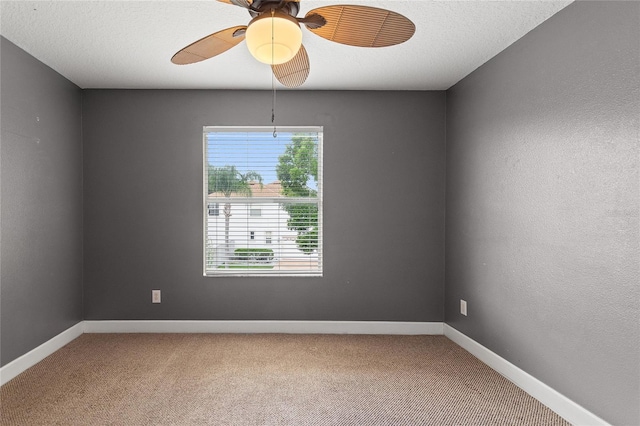 empty room featuring ceiling fan, carpet flooring, and a textured ceiling