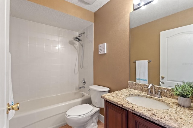 full bathroom with tiled shower / bath combo, vanity, a textured ceiling, and toilet