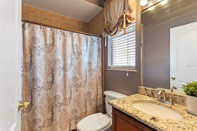 bathroom featuring vanity, toilet, a shower with shower curtain, and a textured ceiling