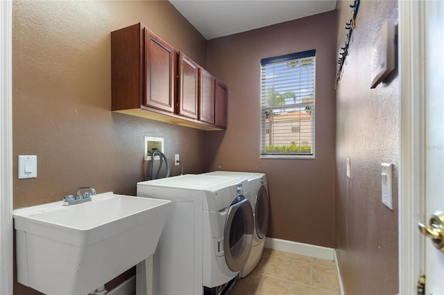 laundry room with cabinets, separate washer and dryer, sink, and light tile patterned floors