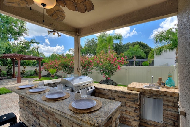 view of patio featuring ceiling fan, area for grilling, a grill, and a pergola