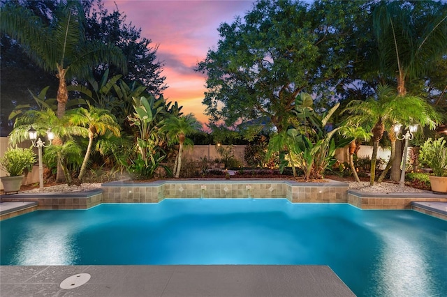 view of pool at dusk