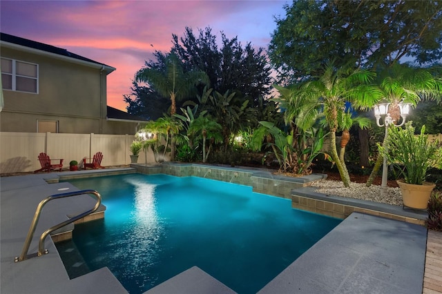 view of pool at dusk