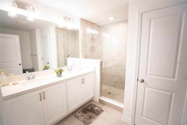 bathroom featuring vanity, a shower with shower door, and tile patterned floors