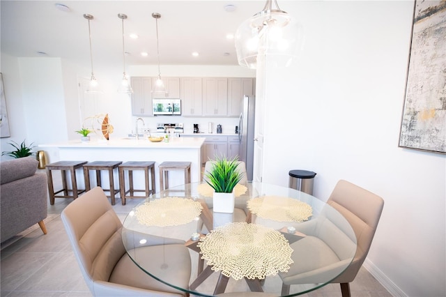 tiled dining space featuring sink