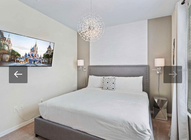 bedroom with carpet and a notable chandelier