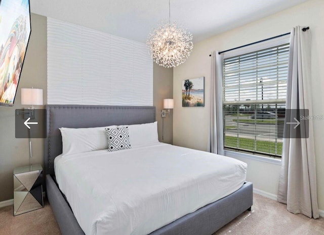 carpeted bedroom with an inviting chandelier