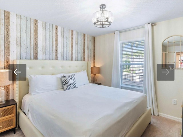 bedroom with a chandelier and carpet flooring