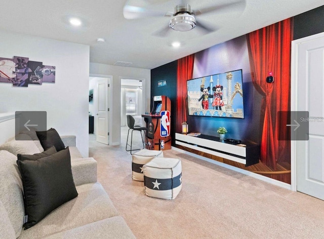 carpeted home theater with ceiling fan