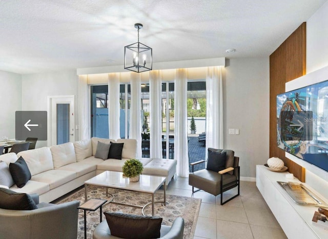 living room featuring an inviting chandelier, light tile patterned floors, and a textured ceiling