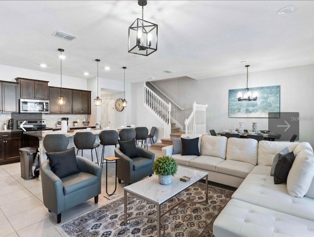 living room featuring an inviting chandelier and light tile patterned floors