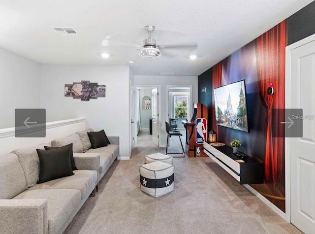 carpeted living room featuring ceiling fan