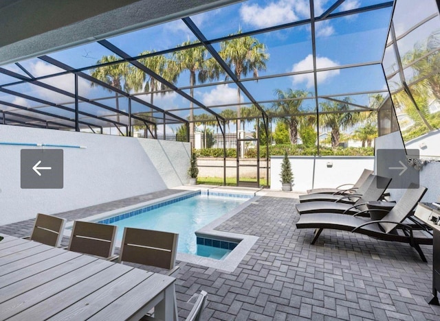 view of swimming pool with a lanai and a patio area