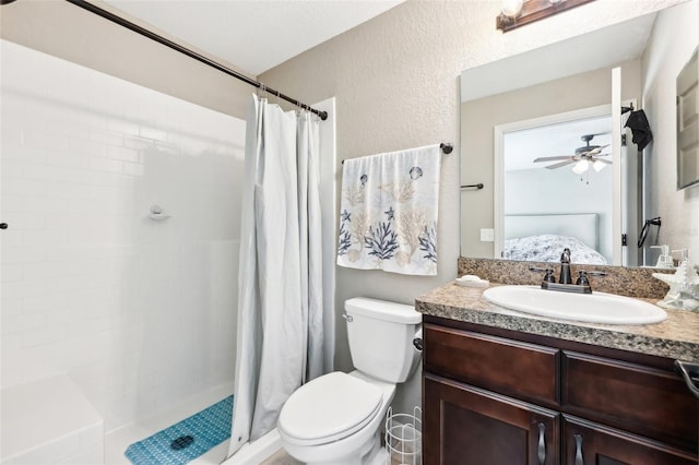 bathroom with vanity, ceiling fan, a shower with curtain, and toilet