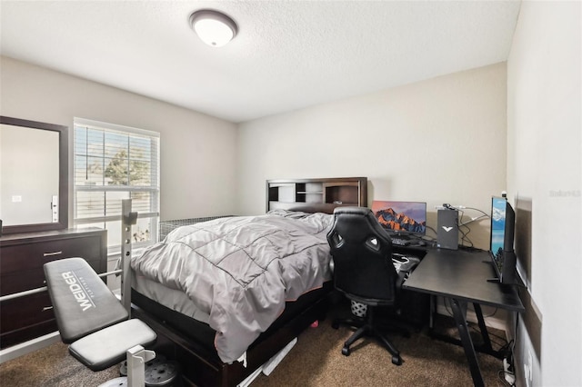 bedroom with carpet floors and a textured ceiling