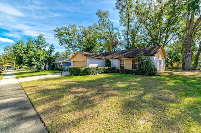 ranch-style home with a garage and a front yard