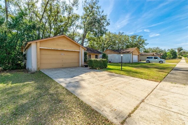 ranch-style house with a garage and a front lawn