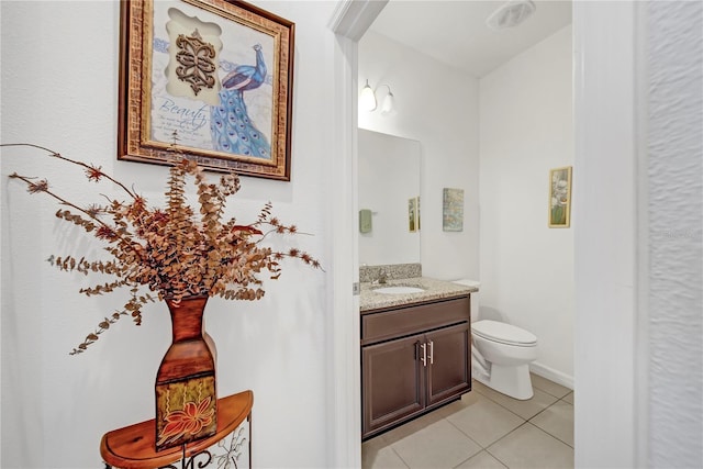 bathroom featuring vanity, tile patterned floors, and toilet