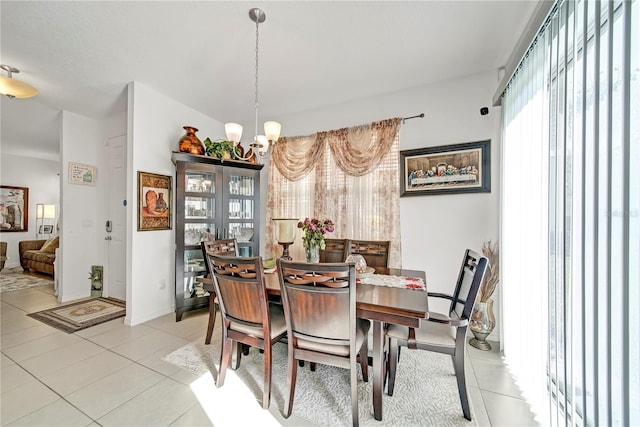 dining area with an inviting chandelier and light tile patterned floors