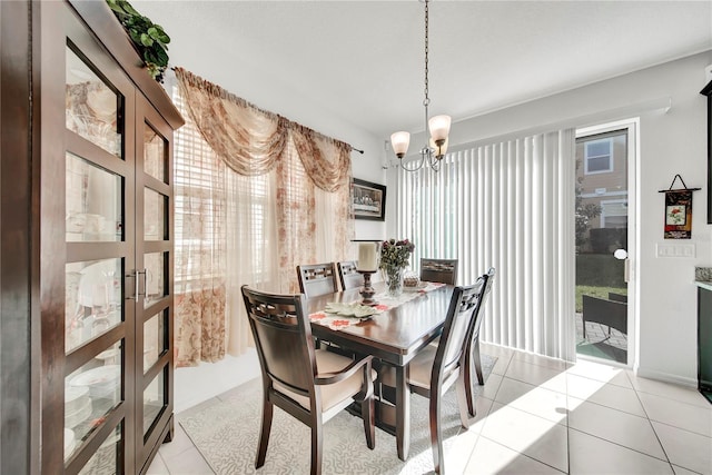 tiled dining space featuring a chandelier