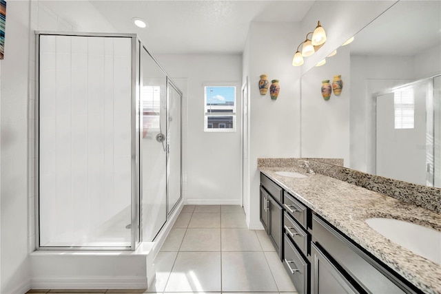 bathroom featuring tile patterned flooring, vanity, and a shower with door