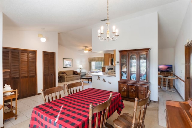 tiled dining area with vaulted ceiling and a notable chandelier