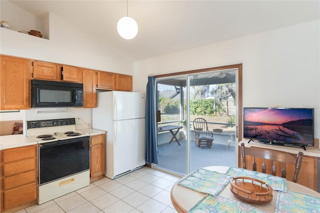 kitchen featuring pendant lighting, light tile patterned floors, and white appliances