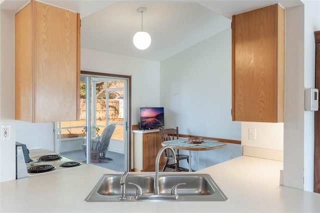 kitchen featuring electric stove, sink, decorative light fixtures, and lofted ceiling