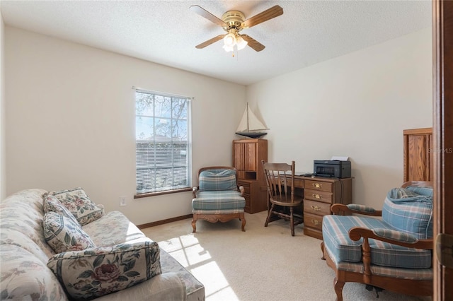 living area with light carpet, a textured ceiling, and ceiling fan