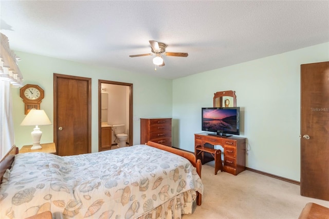 carpeted bedroom featuring connected bathroom, ceiling fan, and a textured ceiling