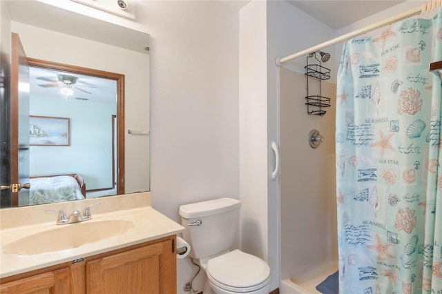 bathroom featuring vanity, toilet, ceiling fan, and a shower with curtain