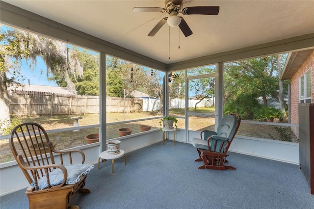 sunroom / solarium featuring ceiling fan