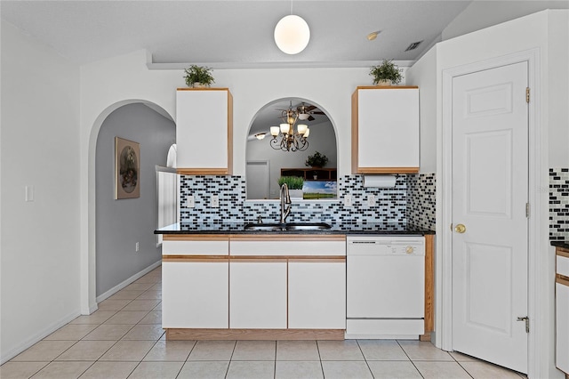 kitchen with hanging light fixtures, white cabinetry, sink, and white dishwasher