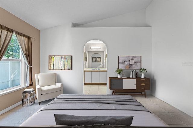 bedroom with lofted ceiling and light tile patterned floors