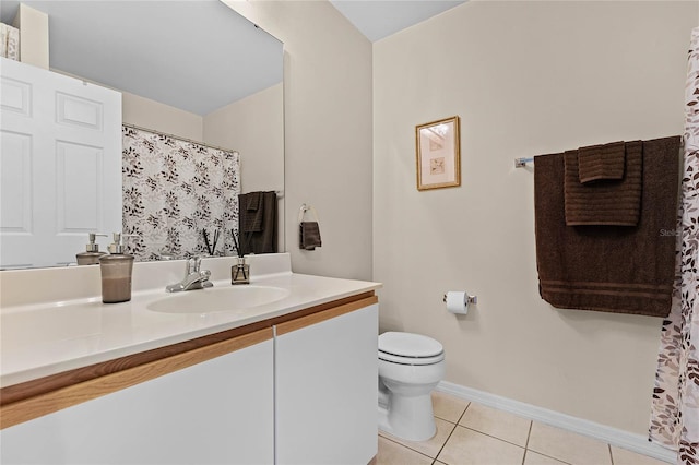 bathroom featuring vanity, tile patterned floors, and toilet