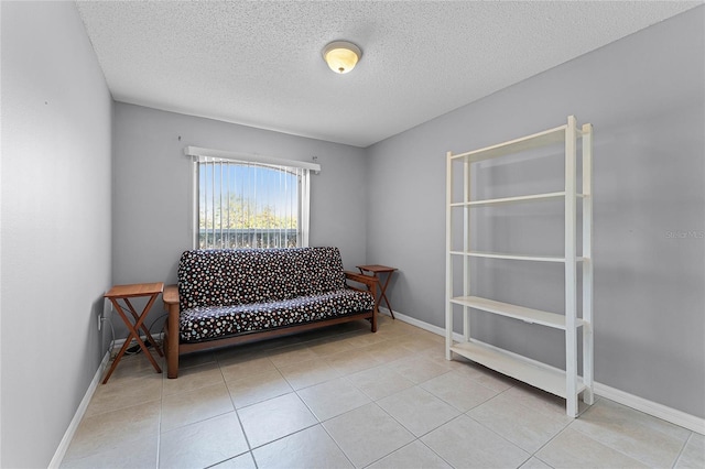 living area with light tile patterned floors and a textured ceiling