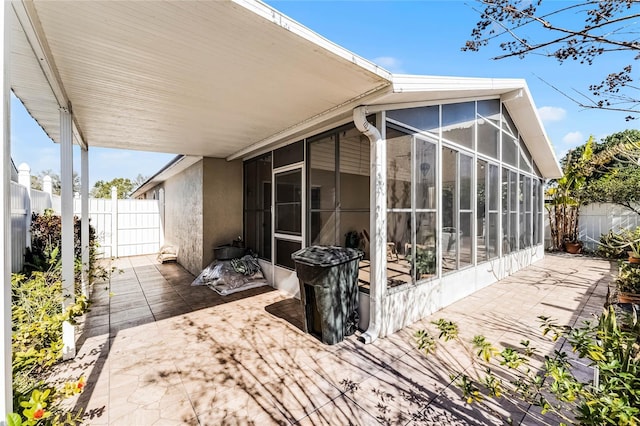 view of home's exterior featuring a patio area and a sunroom