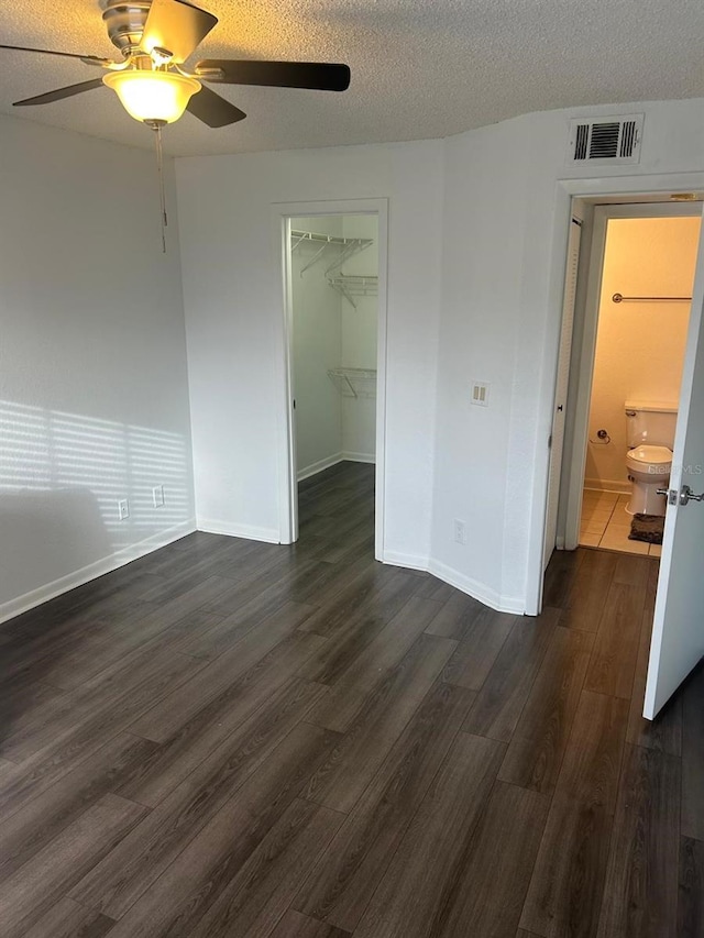 empty room featuring dark hardwood / wood-style floors and a textured ceiling