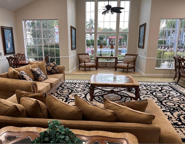 living room featuring ceiling fan and high vaulted ceiling