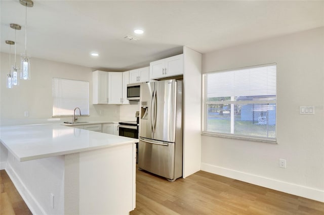 kitchen featuring stainless steel refrigerator with ice dispenser, kitchen peninsula, hanging light fixtures, and white cabinets