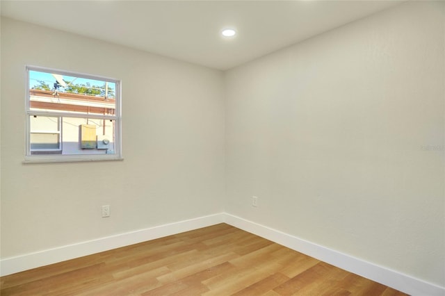 spare room with hardwood / wood-style floors