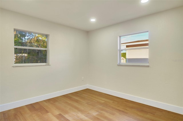 unfurnished room featuring hardwood / wood-style floors and plenty of natural light