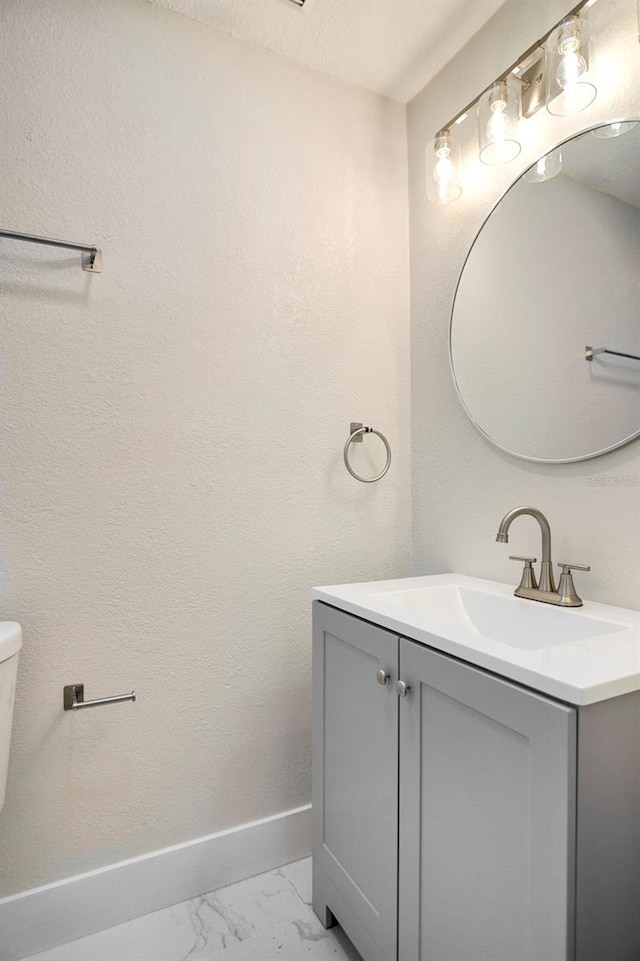 bathroom featuring vanity and toilet