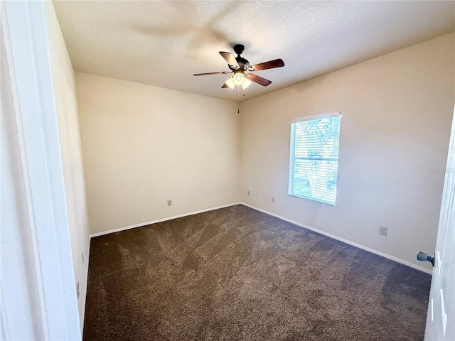 carpeted empty room featuring ceiling fan and a textured ceiling