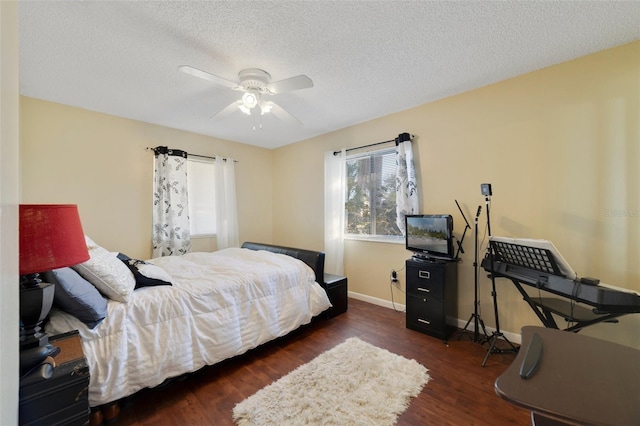 bedroom with ceiling fan, dark hardwood / wood-style floors, and a textured ceiling