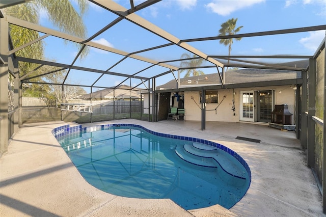 view of swimming pool featuring a lanai and a patio area