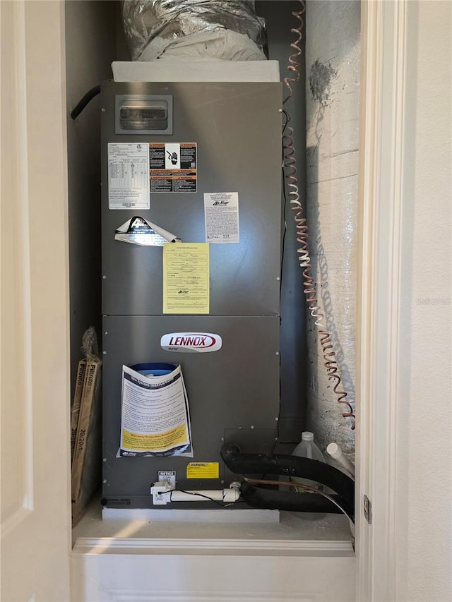 utility room featuring heating unit